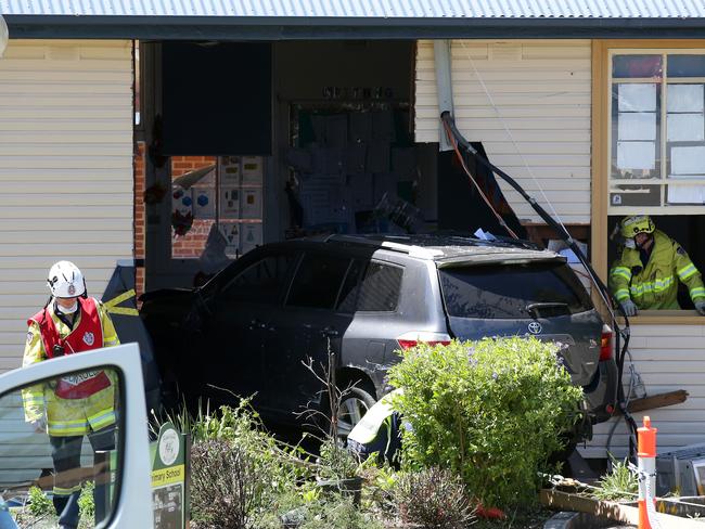 NSW Fire &amp; Rescue officers work to remove the car yesterday. Picture: Jonathan Ng