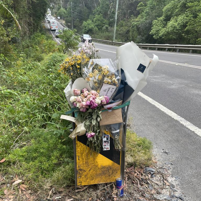 Floral tributes and cards left on a steel railing in memory of a woman, aged in her 20s, who died on September 13 in a two-car crash on Empire Bay Rd, Empire Bay. Picture: NewsLocal