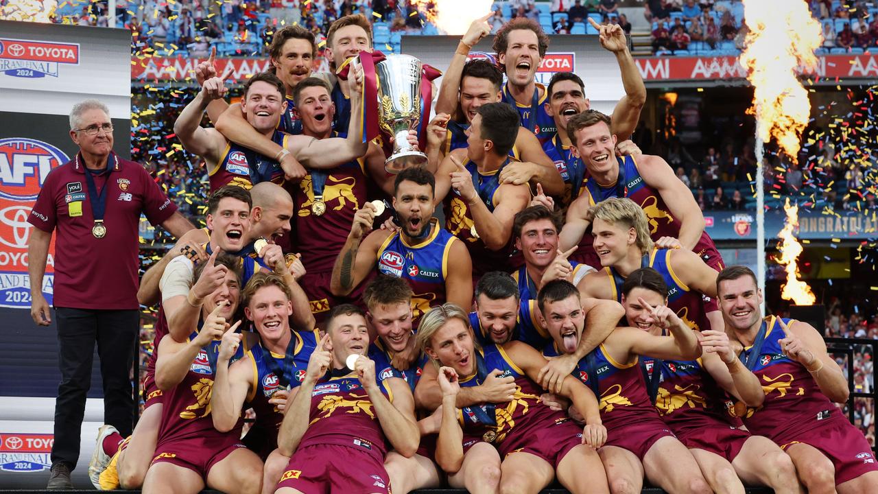 Brisbane Lions players celebrate with the premiership cup after winning the AFL Grand Final after defeating the Sydney Swans at the MCG. Picture Lachie Millard