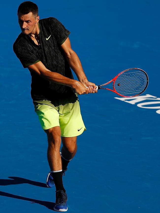 Bernard Tomic plays a backhand.