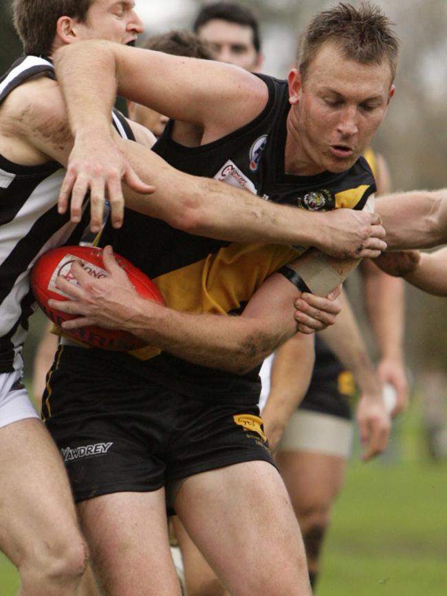 Heidelberg’s Dale Nolan can’t escape the tackle.