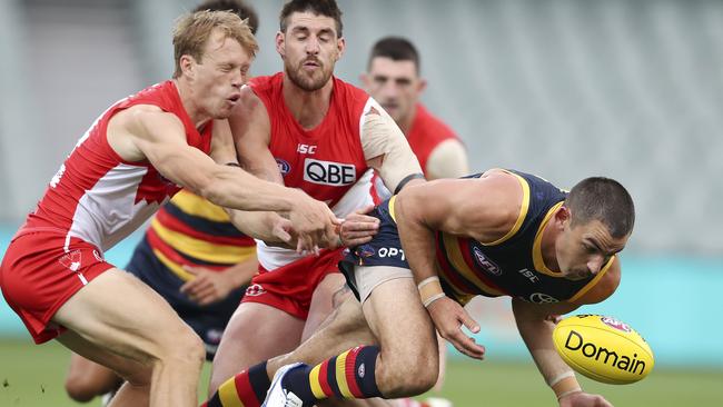 Crows forward Taylor Walker is tackled by Sydney’s Callum Mills (left) and Sam Naismith during the round one clash at Adelaide Oval. Picture Sarah Reed