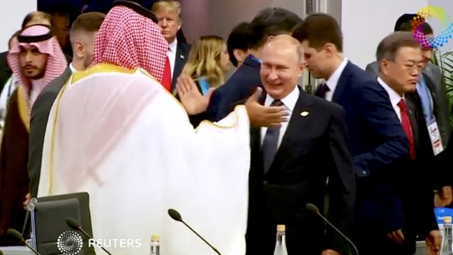 The crown prince high-fives President Vladimir Putin in 2018 following the murder of Jamal Khashoggi. Picture: Reuters