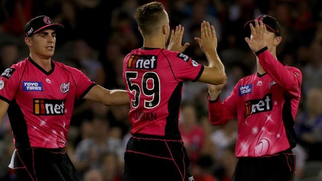 Sydney Sixers bowler Tom Curran (centre) celebrates taking the wicket of the Renegades’ Tim Ludeman on Wednesday night. Picture: AAP  