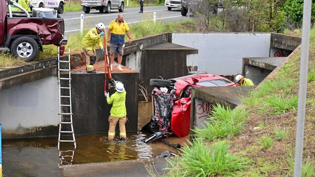 The Mitsubishi Outlander was pushed down a culvert after it was hit head-on by a Nissan Navara in wet weather. The forensic crash unit is investigating. Picture: John McCutcheon