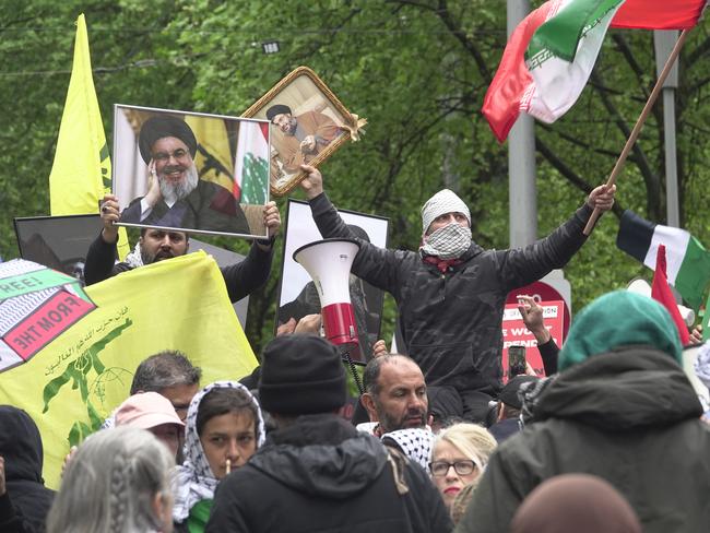 Authorities are being urged to clamp down on protesters displaying the flag of Hezbollah, seen in yellow. Picture: Valeriu Campan