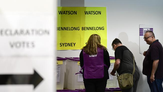 Australian Electoral Commission workers assist voters at a pre-pooling booth at Central Station, Sydney, Monday, April 29, 2019. The Australian Electoral Commission has opened Early voting for the 2019 Federal Election, with the expectation that the election is set to attract record numbers of pre-poll votes. (AAP Image/Bianca De Marchi) NO ARCHIVING