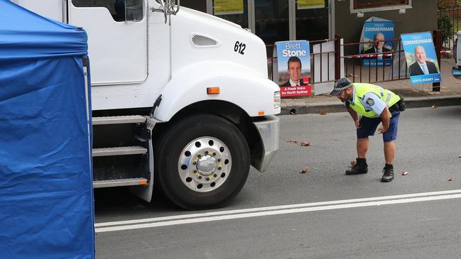 A policeman examines a cement truck at the Crow Nest crime scene. Picture: Richard Dobson