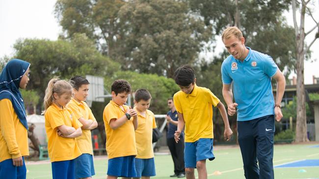 Melbourne City FC footballer Tom King takes Moreland Primary School students through the ropes.