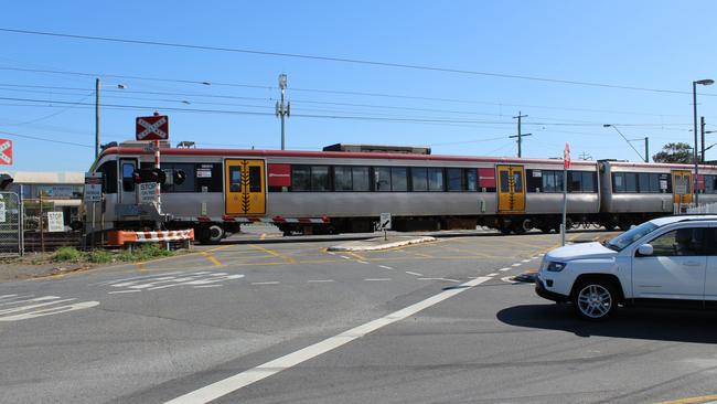 A train passes through the notorious Lindum rail crossing. Picture: Damian Bathersby