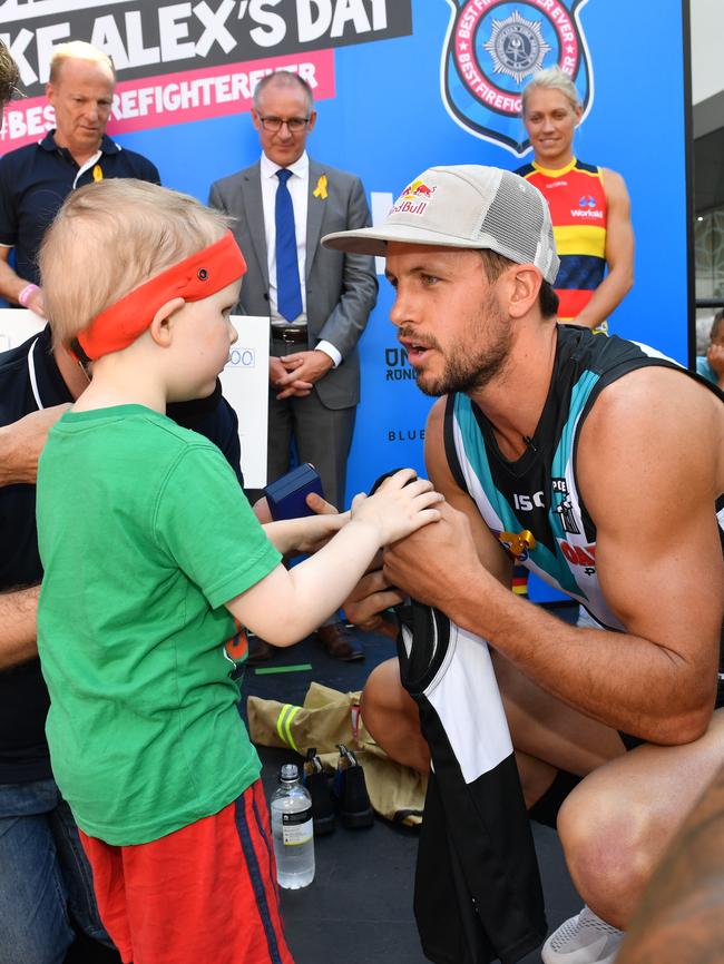 Port Adelaide Football Club captain Travis Boak thanks Alex for rescuing him and Adelaide Crows's AFLW player Erin Phillips from the Beehive Corner building. Picture: Keryn Stevens