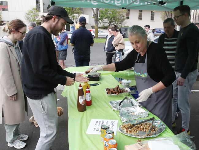 Democracy sausages in full flow at an East Melbourne voting booth. Picture: David Crosling/NCA Newswire