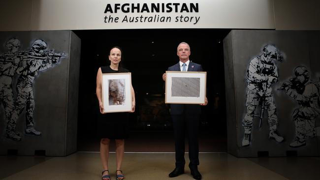 Australian War Memorial Senior Curator of Photo, Film and Sound, Magda Keaney, and director Brendan Nelson with Richard Drew’s images. (Pic: Gary Ramage)