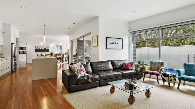 The open-plan living, dining and kitchen area looks out to the pool.