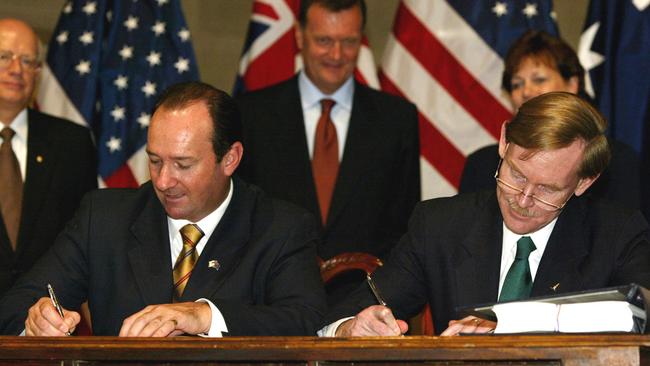 Then Australian Trade Minister Mark Vaile, left, and US Trade Representative Robert Zoellick sign the United States and Australia free trade agreement in Washington, 2004.
