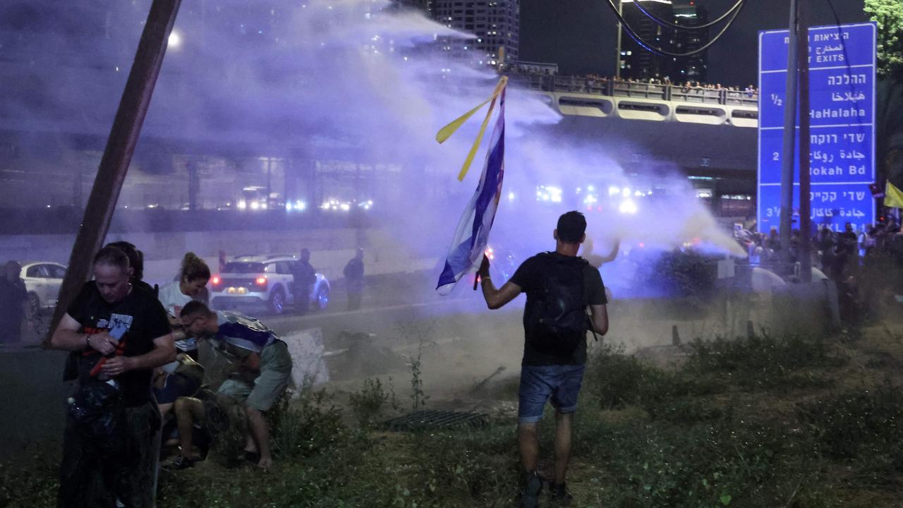 Israeli security forces use water cannon to disperse a left-wing anti-government demonstration in Tel Aviv. Picture: AFP