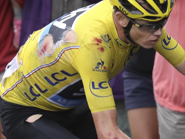 Britain's Chris Froome, wearing his torn overall leader's yellow jersey, bleeds after crashing during the nineteenth stage of the Tour de France cycling race over 146 kilometers (90.7 miles) with start in Albertville and finish in Saint-Gervais Mont Blanc, France, Friday, July 22, 2016. (Keno Tribouillard via AP Photo)