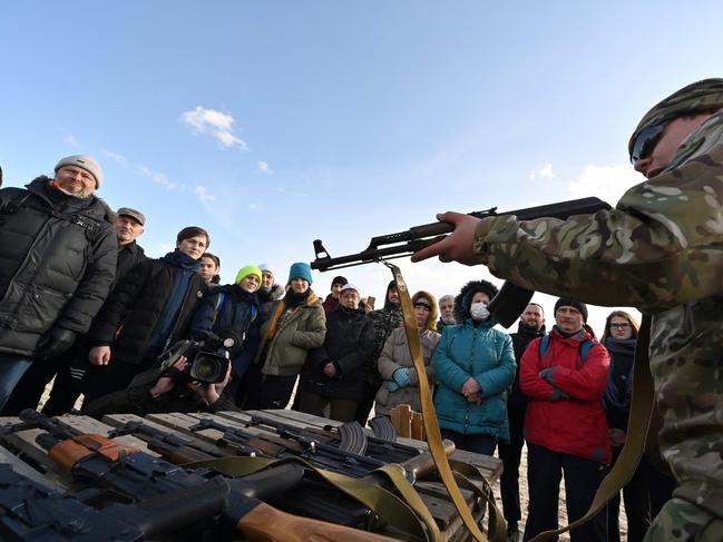 Residents attend an open training organised for civilians by war veterans and volunteers who teach the basic weapons handling and first aid on one of Kiyv's city beaches. Picture: AFP