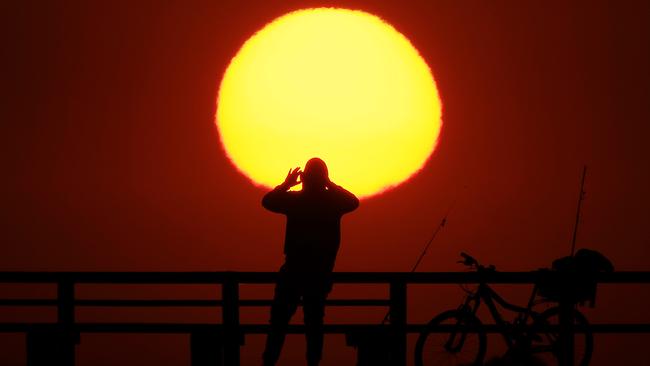 The sun sets at Middle Park beach ahead of several days of hot weather. Picture: Mark Stewart