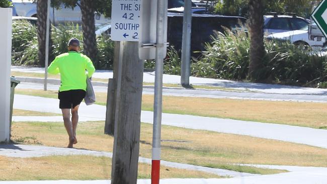 Man running from witnesses at Main Beach after allegedly being sprung masturbating near 13-year-old girls. Picture: Scott Powick.