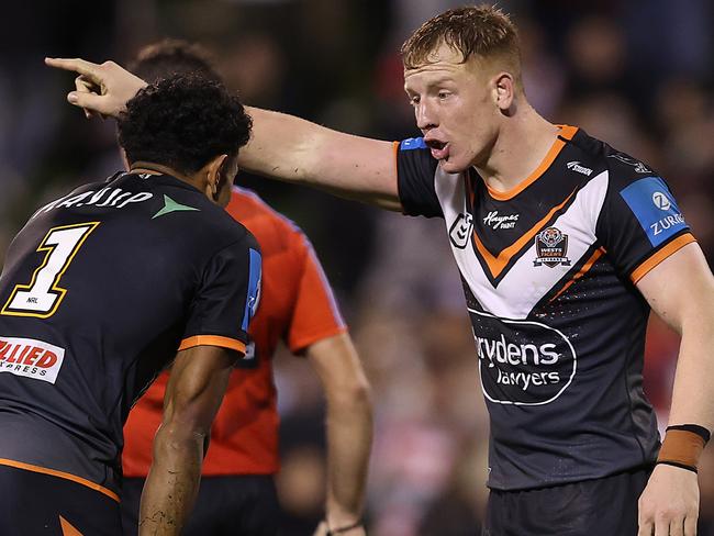 WOLLONGONG, AUSTRALIA - JUNE 07:  Alex Seyfarth of the Wests Tigers talks to team mate Jahream Bula during the round 14 NRL match between St George Illawarra Dragons and Wests Tigers at WIN Stadium on June 07, 2024, in Wollongong, Australia. (Photo by Jason McCawley/Getty Images)