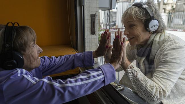 Felicia Waininger, 90, and her daughter Lilian visit through a window at Hogar Israelita nursing home in Montevideo, Uruguay. Picture: Getty Images