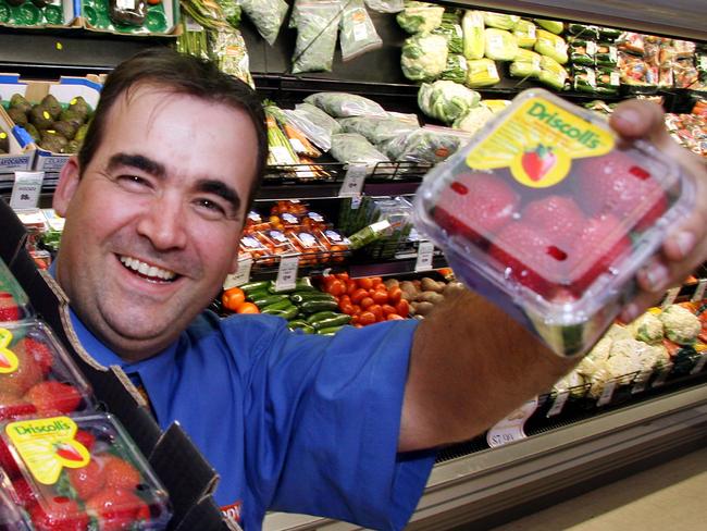 Chris Antonieff showcasing punnets of strawberries in the fresh fruit and vegetable section of his Oxley FoodWorks grocery store