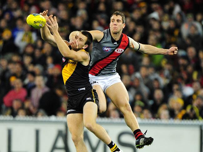 Brett O'Hanlon takes a strong mark for Richmond in front of Essendon’s Kyle Hardingham at the MCG.