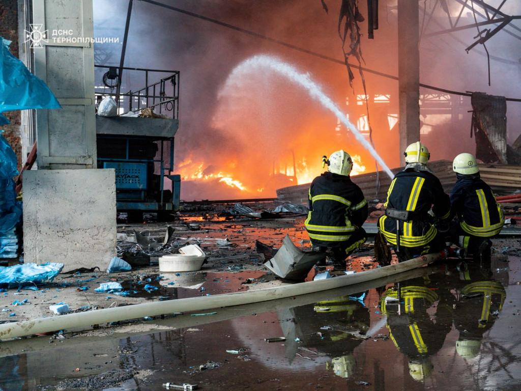 Firefighters extinguish a blaze in an industrial facility following Russian strike in Ternopil region. Picture: AFP