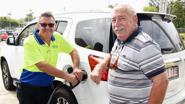 Chris Taylor and customer Harry Cramer are excited about the price of fuel. Picture: Lawrence Pinder