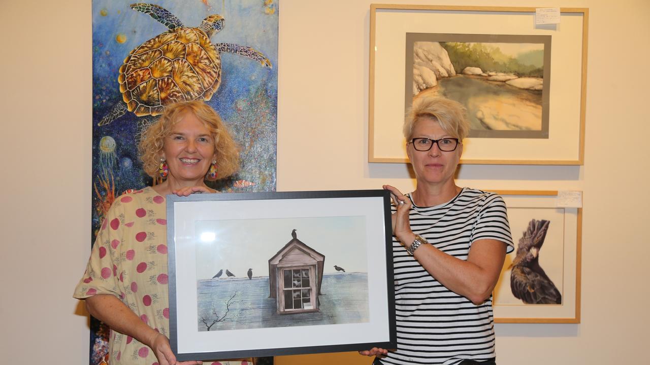 Cairns Arts Society secretary Joanne Bingham and Cairns Art Gallery curator Kylie Burke get ready for the Cairns Art Society 76th anniversary exhibition opening on February 2. Picture: Catherine Duffy.