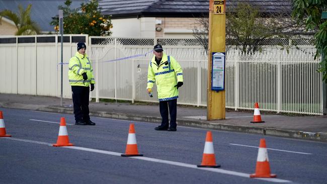 Officers examining Morphett Rd. Picture: Mike Burton/AAP