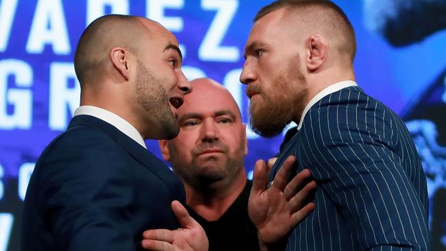 Conor McGregor (R) and Eddie Alvarez face-off as UFC president Dana White breaks them up.