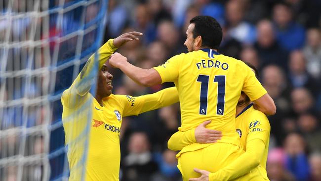 BRIGHTON, ENGLAND - DECEMBER 16:  Pedro of Chelsea celebrates with teammate Eden Hazard and Willian after scoring his team's first goal during the Premier League match between Brighton & Hove Albion and Chelsea FC at American Express Community Stadium on December 15, 2018 in Brighton, United Kingdom.  (Photo by Mike Hewitt/Getty Images)