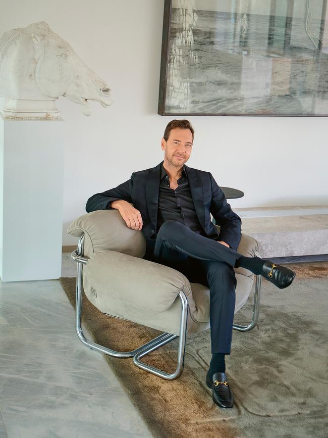 Alex at home in Sydney’s Potts Point, wearing P. Johnson tuxedo, Hugo Boss shirt and Gucci shoes, surrounded by artwork from his mother Carla Zampatti’s collection, including the replica of Phidias’s Selene Horse and an Anselm Kiefer painting. Photo: Nic Walker
