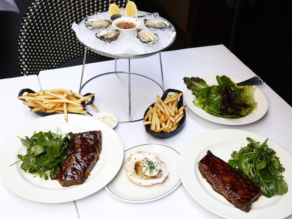 At some point in our lunch we both realise we’ve been so engrossed in our conversation that our meals – les steaks frites, faux-fillet wagyu sirloin with entree of oysters and scallops – are going cold. Picture: Jonathan Ng