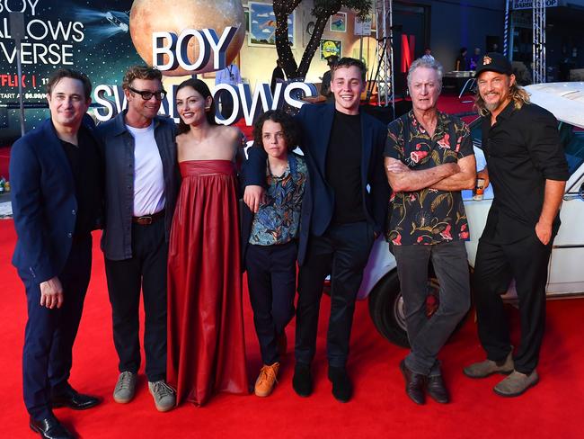 (L-R) Trent Dalton, Simon Baker, newly engaged Phoebe Tonkin, Felix Cameron, Lee Tiger Halley, Bryan Brown and Travis Fimmel at the Netflix global premiere of ‘Boy Swallows Universe’ Picture: Getty Images