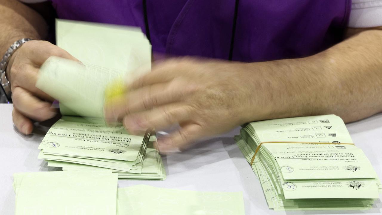 Volunteers counting some of Australia’s 18 million votes. Picture: Martin KEEP / AFP