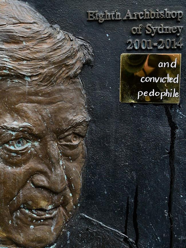 A plate reading 'and convicted paedophile' is seen on the plaque of former Sydney Archbishop George Pell at St Mary's Cathedral in Sydney. Picture: Bianca De Marchi/AAP