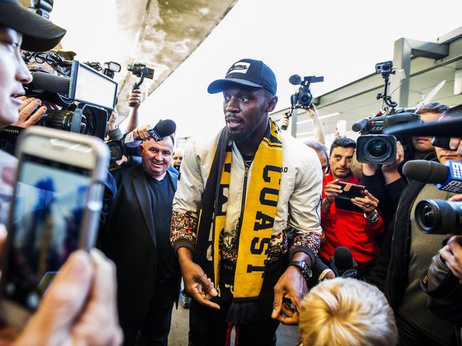 Bolt arrives at Sydney International airport on Saturday morning ahead of his first training run today with the Mariners. Picture: Jenny Evans.