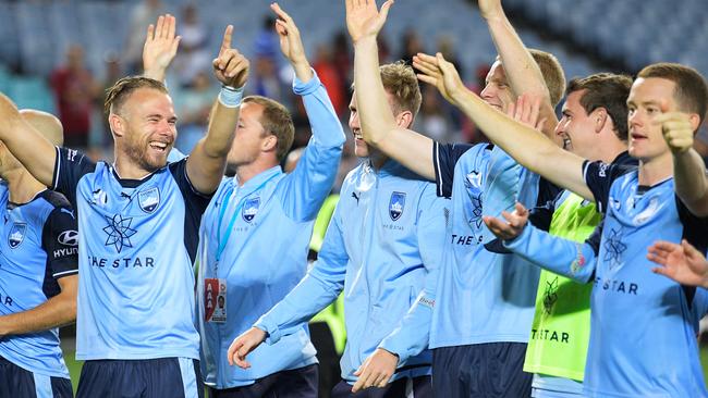 Sydney FC players celebrate their big win over Western Sydney Wanderers on Saturday night.