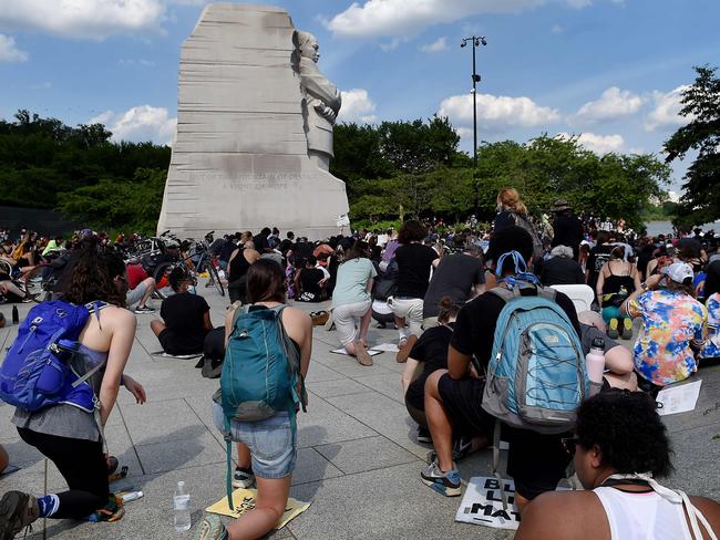 Demonstrators kneel down as they gather at The Martin Luther King Jr. Memorial. Picture: AFP