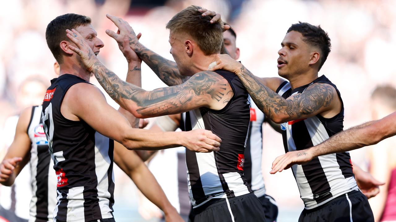 MELBOURNE, AUSTRALIA - SEPTEMBER 30: Jordan De Goey of the Magpies celebrates a goal with teammates during the 2023 AFL Grand Final match between the Collingwood Magpies and the Brisbane Lions at the Melbourne Cricket Ground on September 30, 2023 in Melbourne, Australia. (Photo by Dylan Burns/AFL Photos via Getty Images)