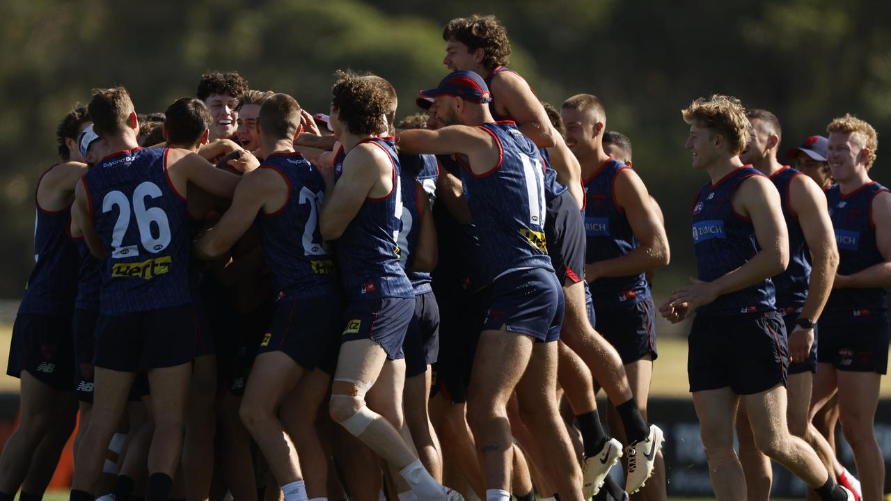 Demons players congratulate Caleb Windsor on being named to debut for Melbourne alongside Blake Howes and Jack Billings. Picture: Getty Images