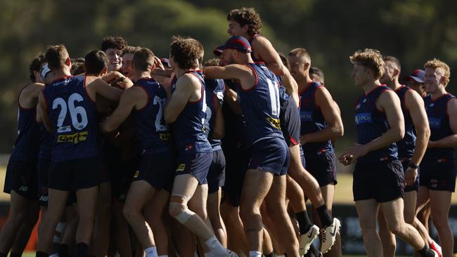 Demons players congratulate Caleb Windsor on being named to debut for Melbourne alongside Blake Howes and Jack Billings. Picture: Getty Images