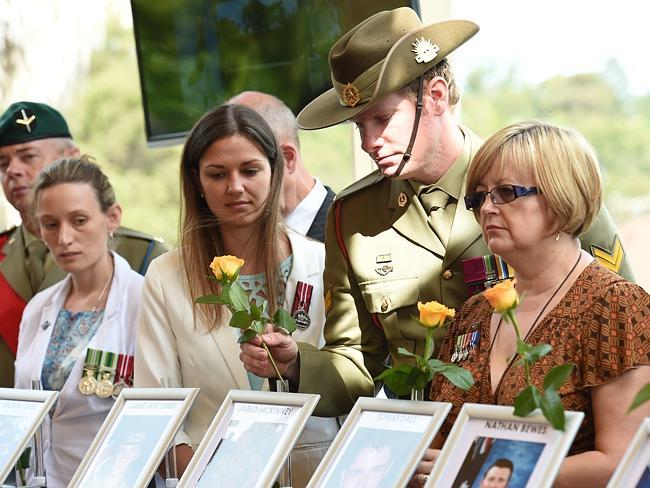 Forever in their debt ... Victoria Cross holder Corporal Dan Keighran joins relatives in putting roses on the fallen Diggers in the Afghanistan war.