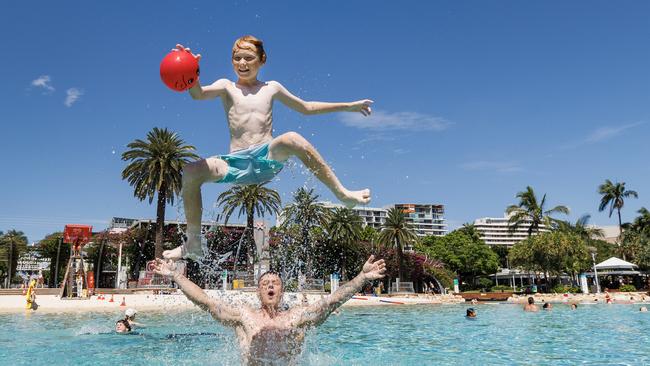 12 year old Jadon Hubble launches from the water with help from dad Matt at Southbank as the summer heat kicks in across Brisbane. Picture Lachie Millard