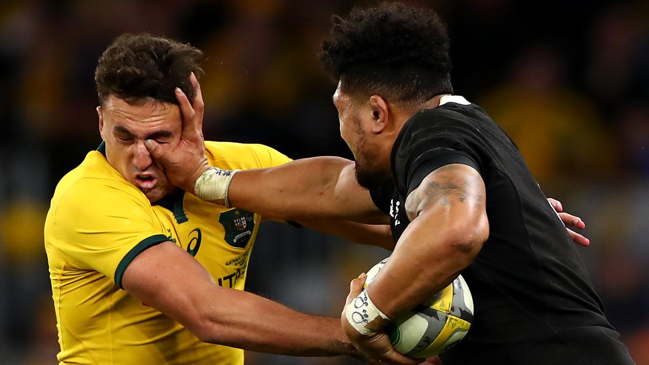 Ardie Savea of the All Blacks fends off Tom Banks of the Wallabies.