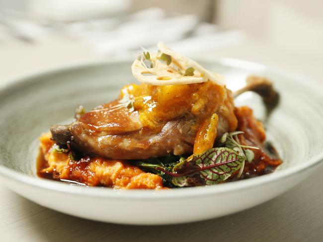 Cardamom and Tamarind Glazed Confit Duck with kumera mash, oyster sauce greens and sticky mandarin at Bistro C Noosa. Photo Lachie Millard