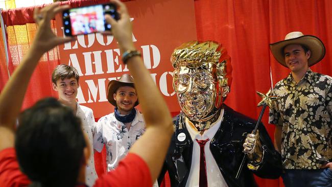 Getting a picture taken with a gold statue of the former president proved popular at the CPAC in Orlando, Florida. Picture: AFP